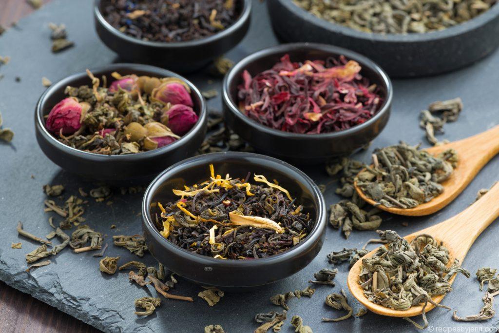 assortment of dry tea in ceramic bowls, close-up